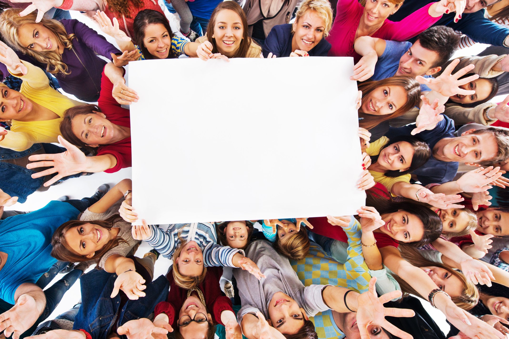 Group of happy people holding white paper.